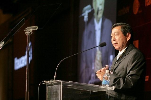 a man giving a speech at an event
