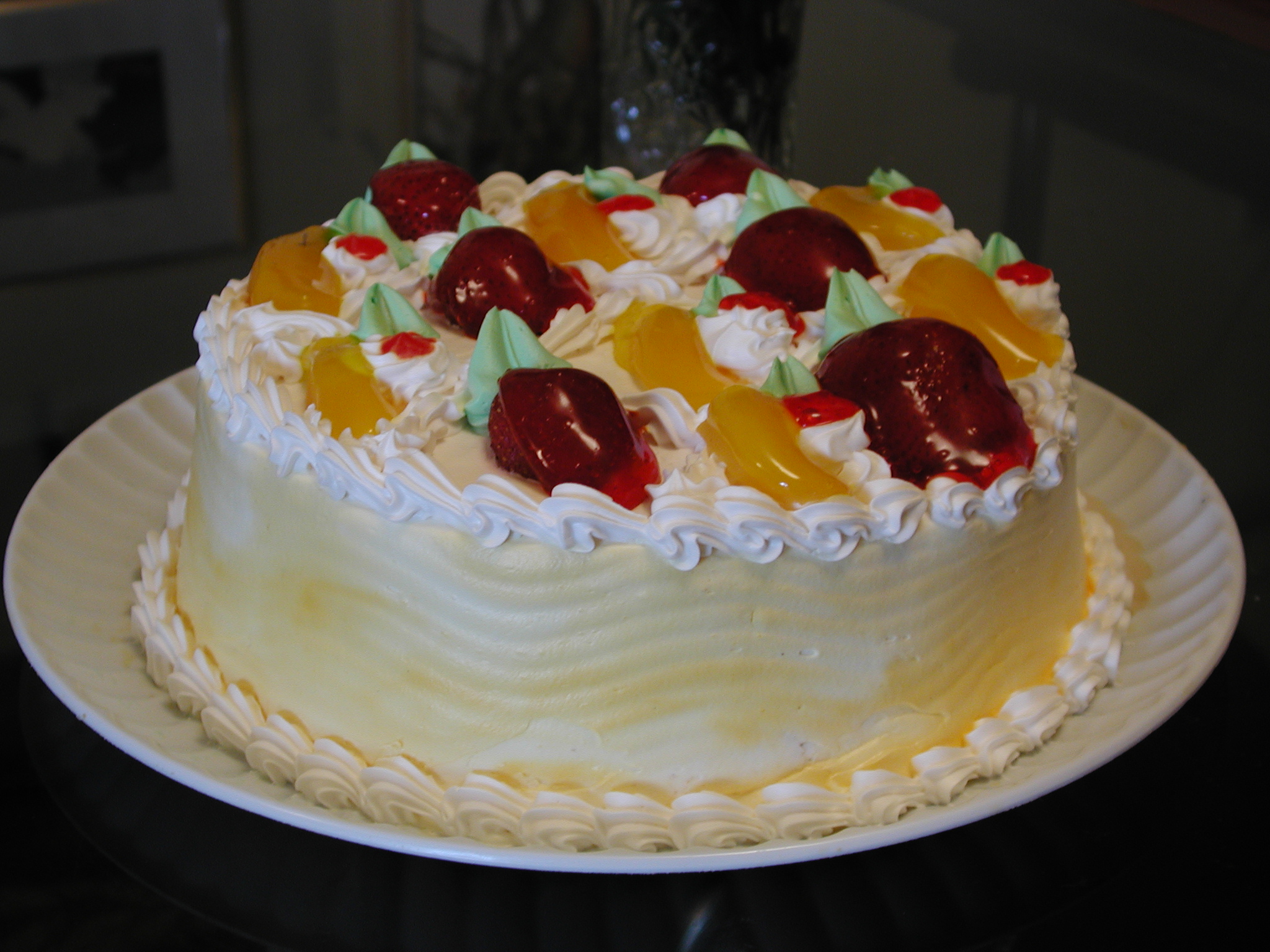 a cake decorated with fresh fruit on a plate