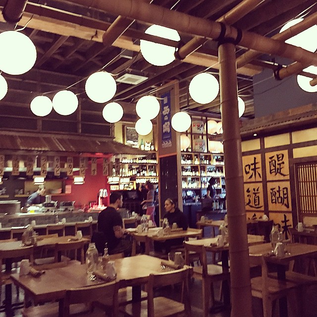 a restaurant with many tables and chairs with chinese characters on them