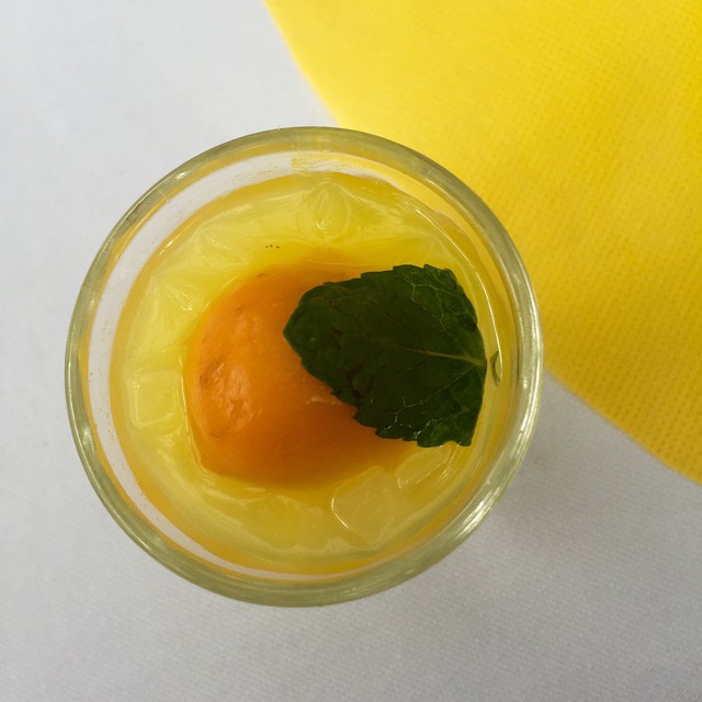 an orange is in a glass of yogurt