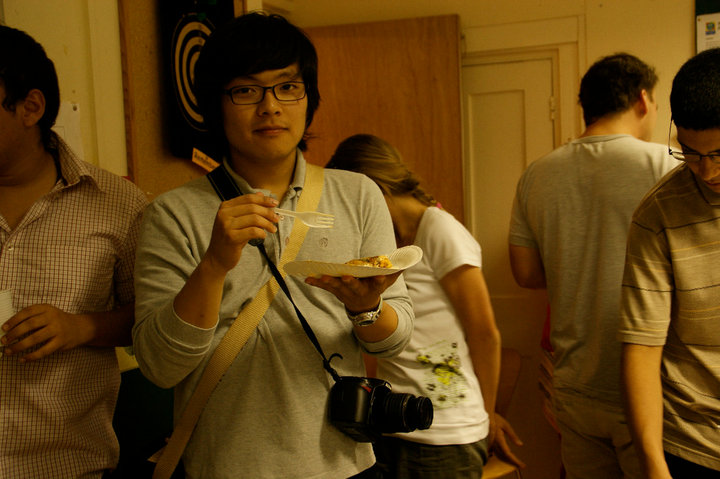 a woman holding a plate of food while wearing glasses