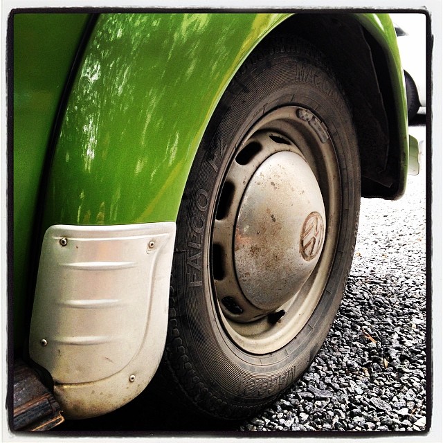 an old bus tire is on the side of a car