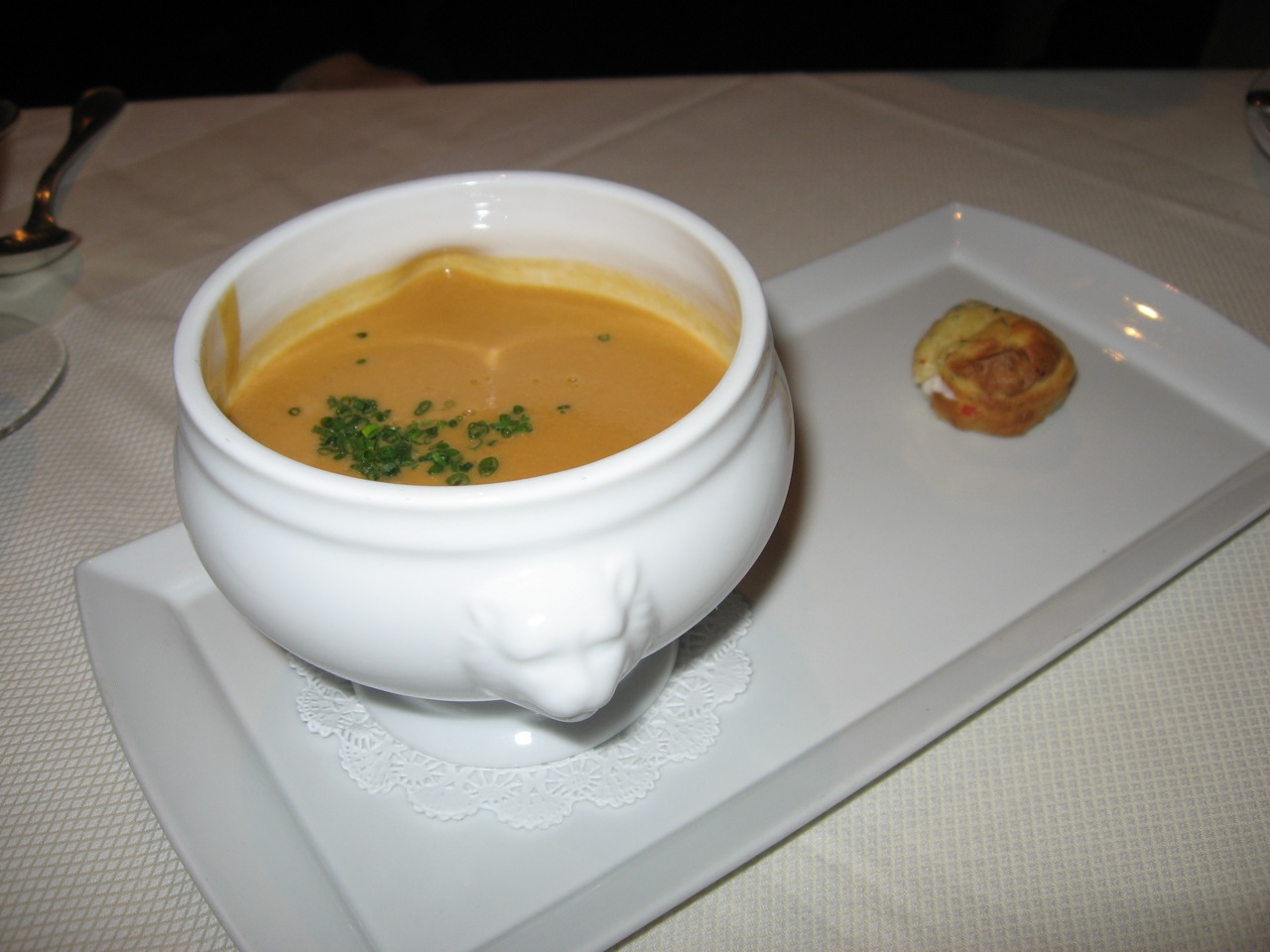 a bowl of soup is on a white plate