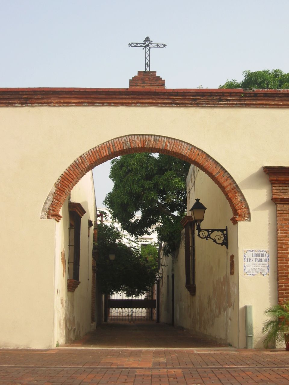 an arched archway leads into an alley that is made of bricks