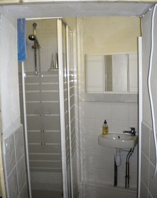 a bathroom with tiled walls and a small sink