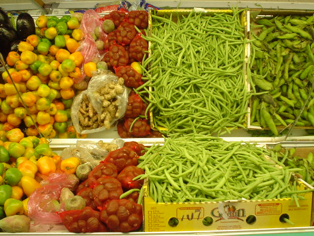 different vegetables sitting on display in bins