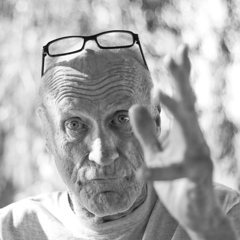 a man with glasses making the vulcan sign