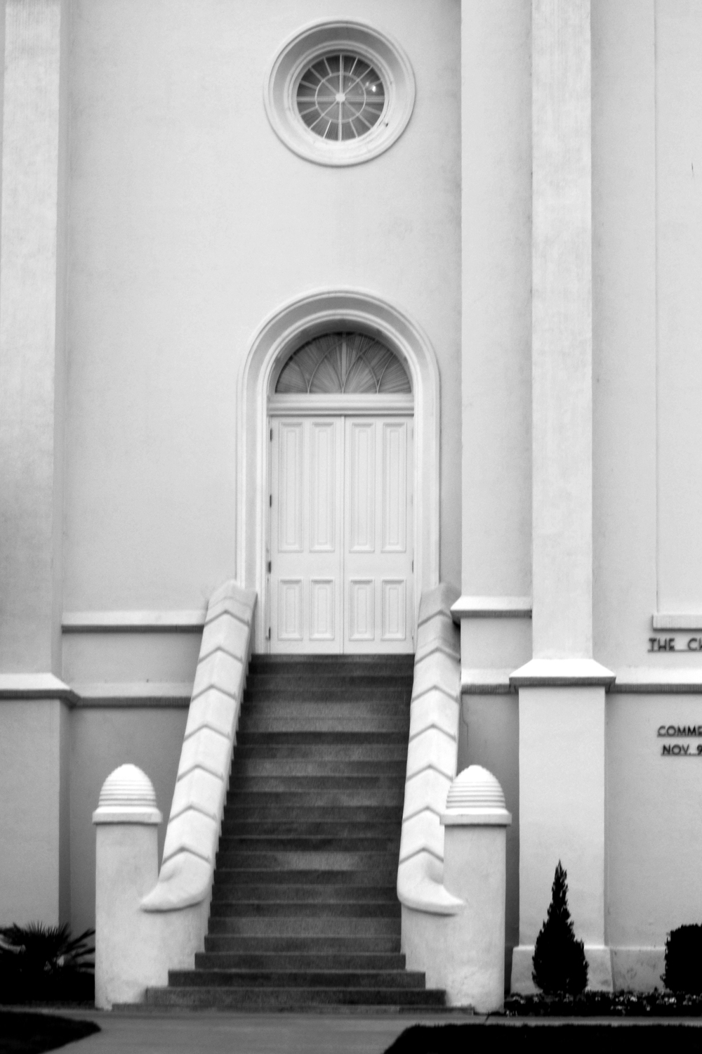 a black and white po of a door on a church