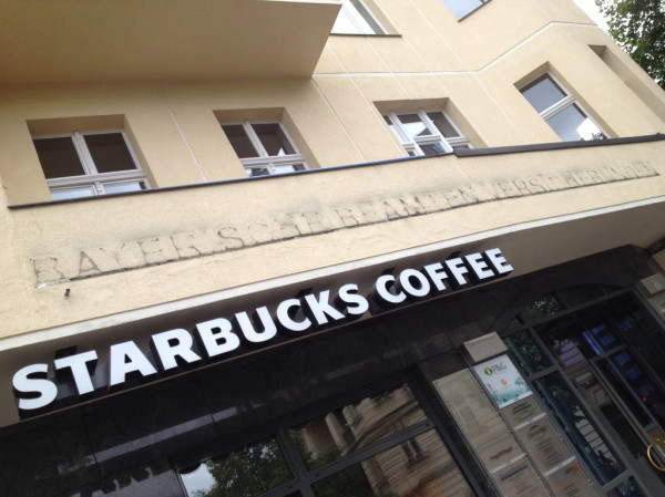 a starbucks has opened in the front of a restaurant