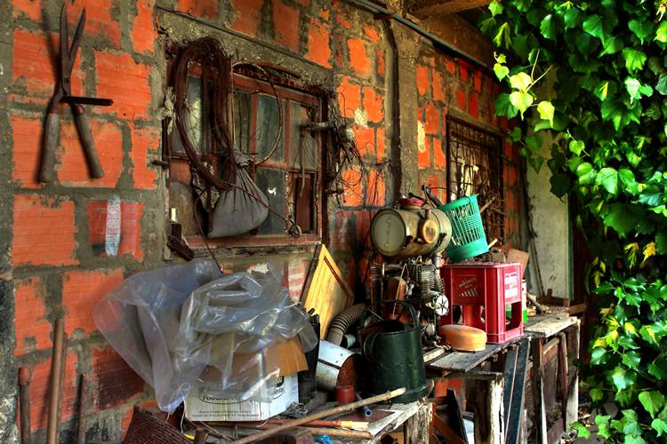 various items are displayed on the wall in an old and rundown home