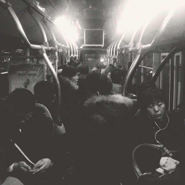 a group of people riding on a subway together