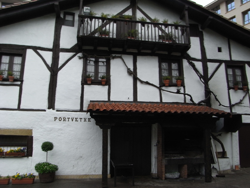 the house has flowers and plants in the front