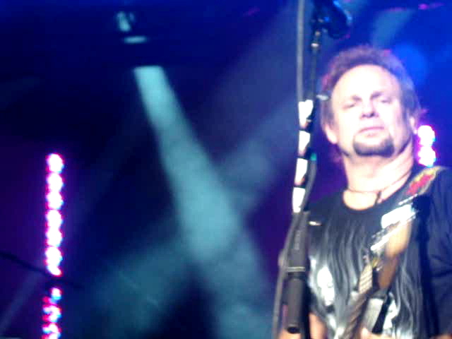 a man standing on stage holding a microphone