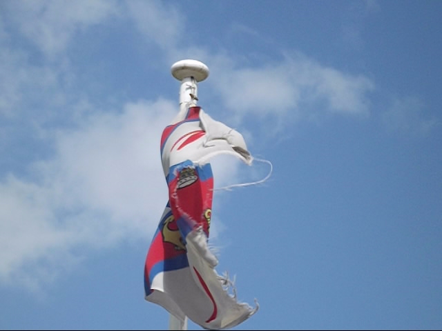 a tall colorful kite flying in the air