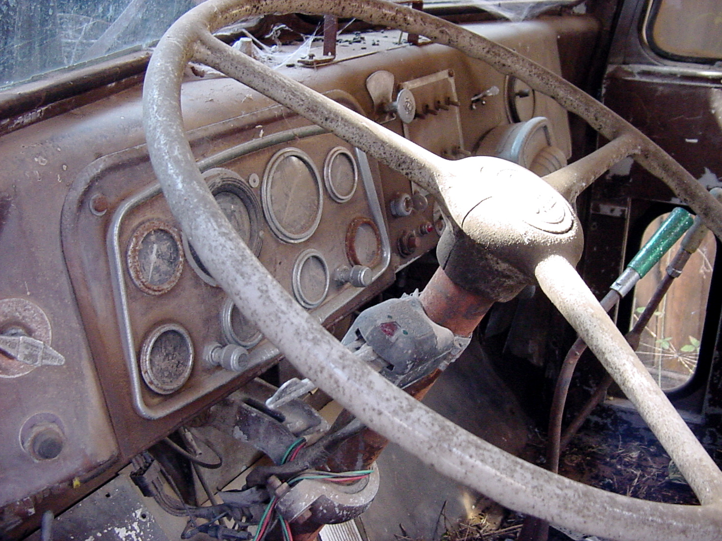 steering wheel and dashboard of an old car in junk