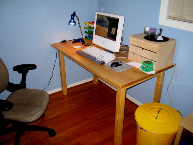 computer desk with keyboard and monitor on wooden table