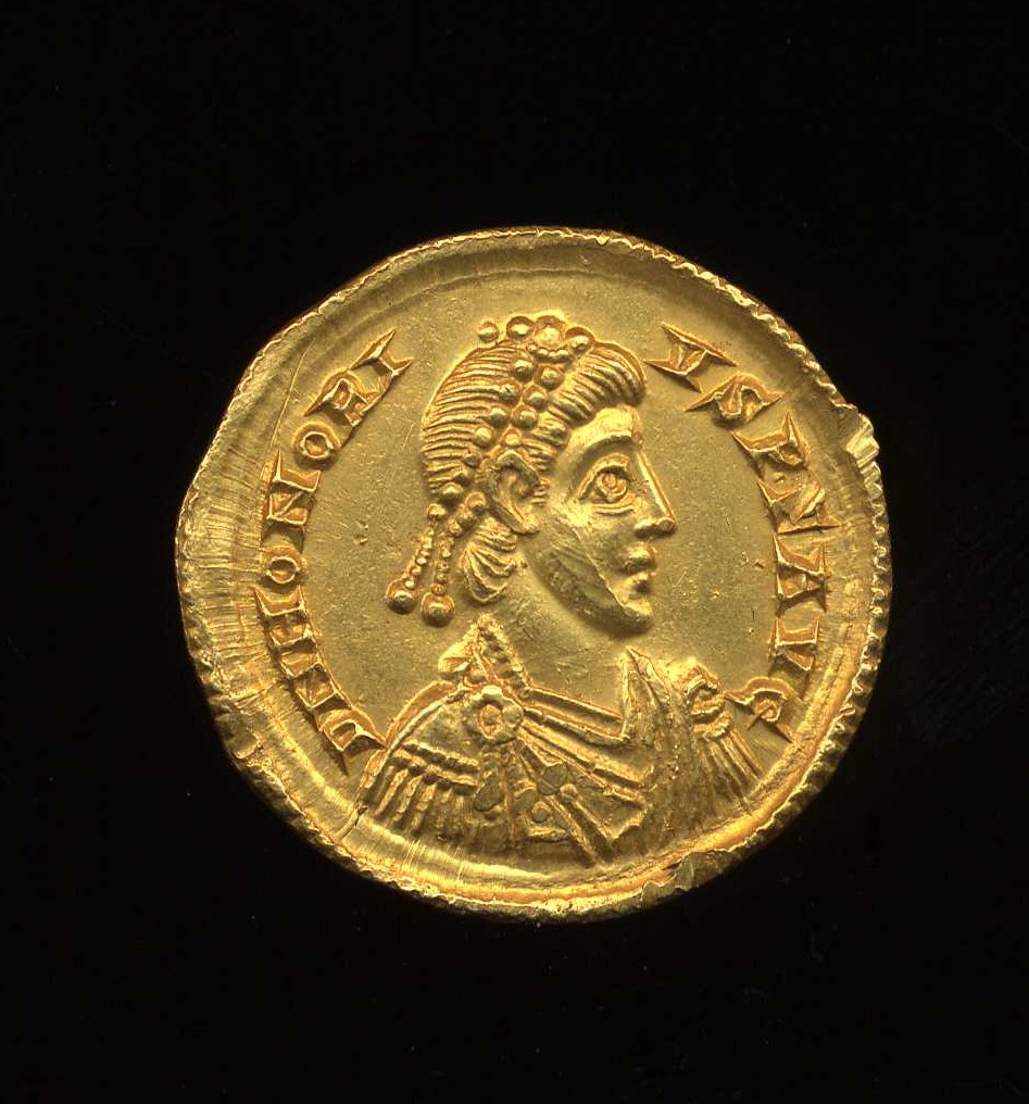 a gold coin with a busted bust on top