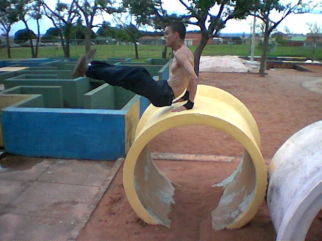 a man is in mid air off a large object