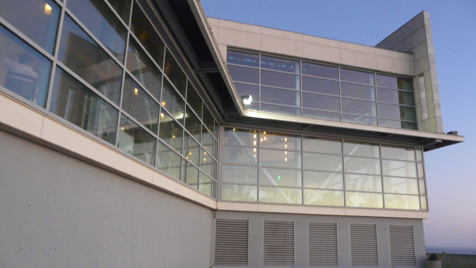 the corner of an office building with some lights on