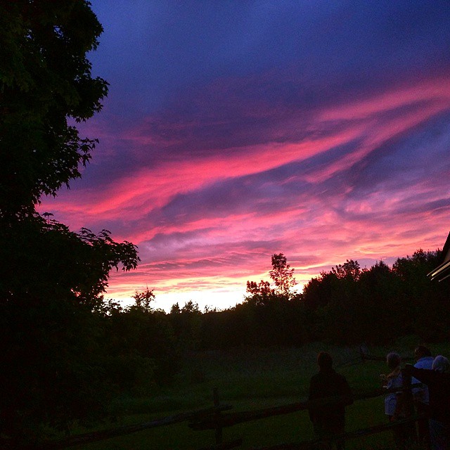 several people are watching the sunset in the distance