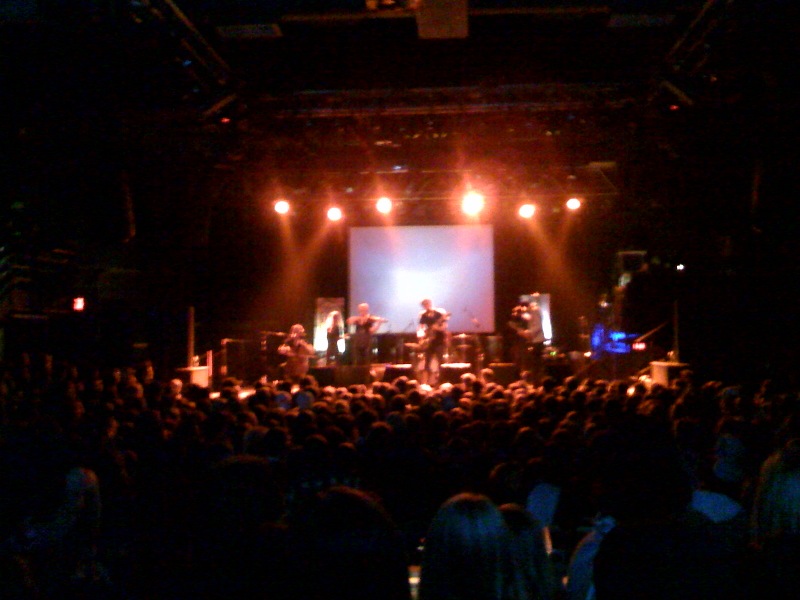 a concert on stage with people in the dark