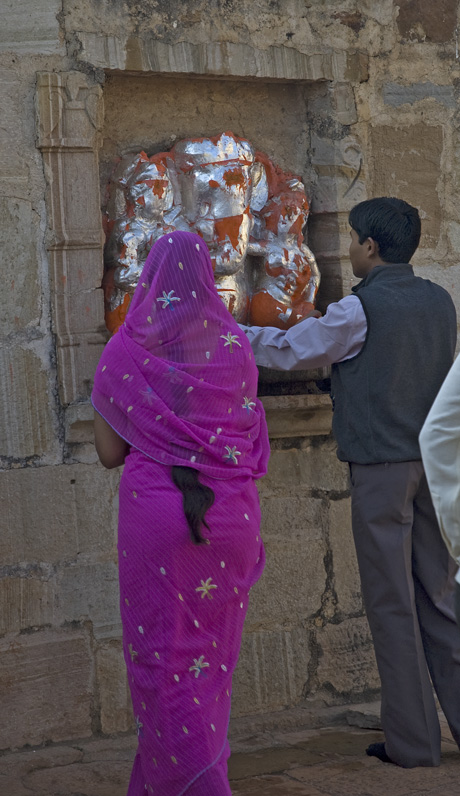 a couple at a temple buying some baked goods