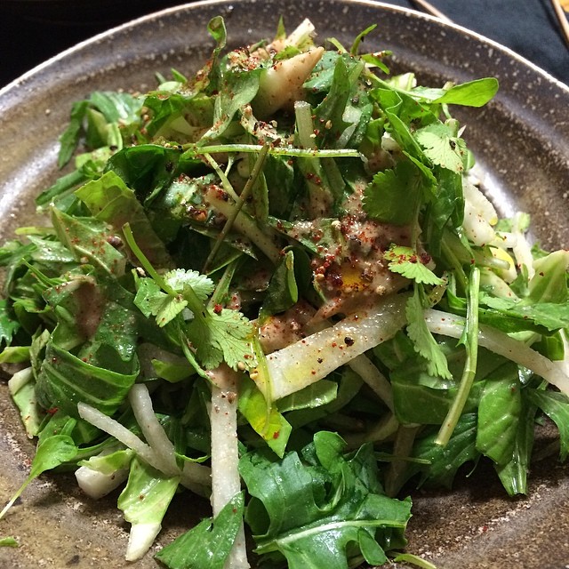 a close up of a plate of salad with greens