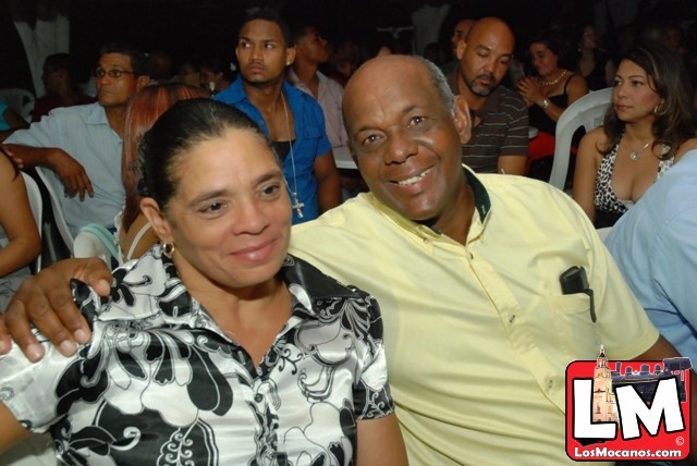 man and woman sitting in front of an audience at a party