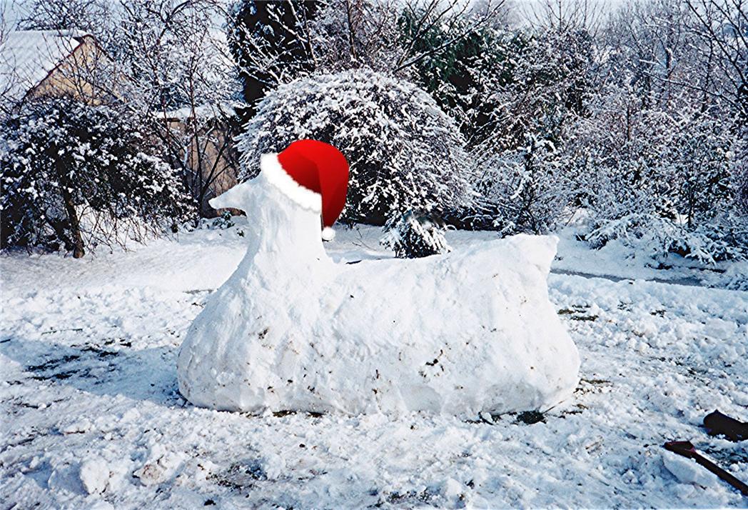 a snowman statue has a red santa claus hat on