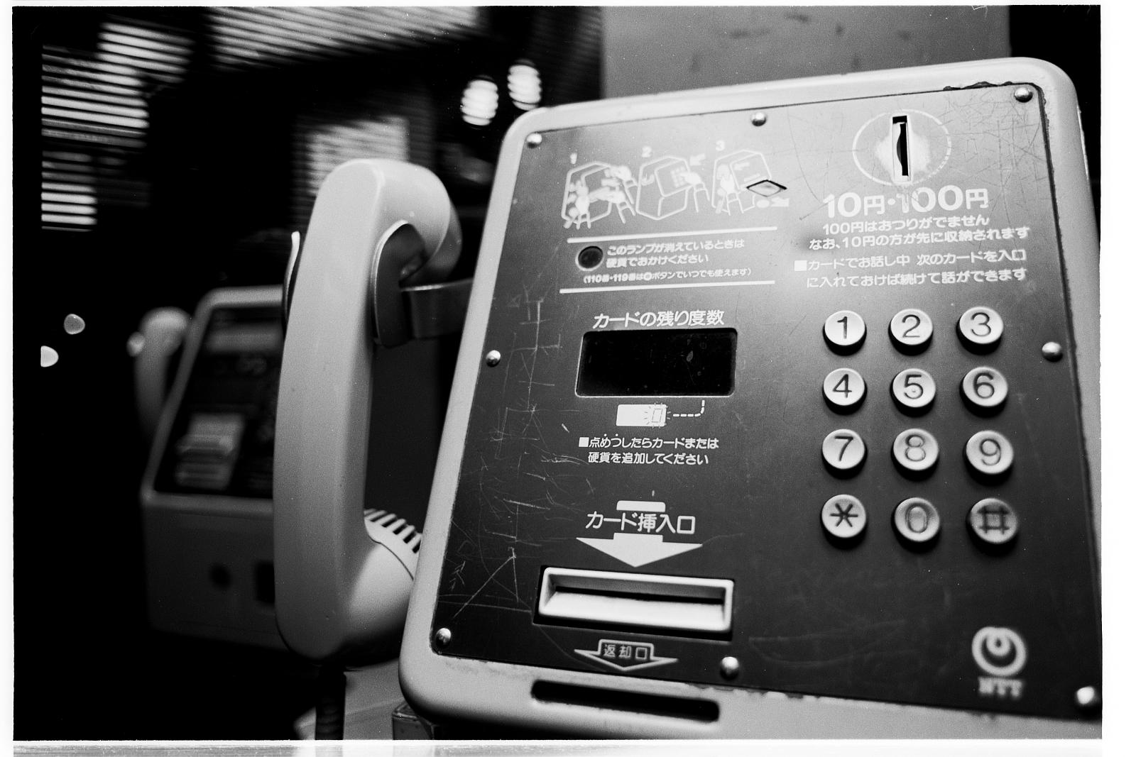 a couple of old fashioned telephones with no receiver