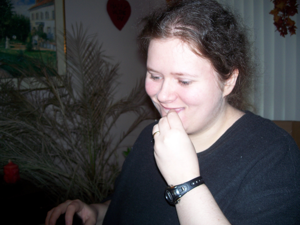 a close up of a woman wearing a wrist watch