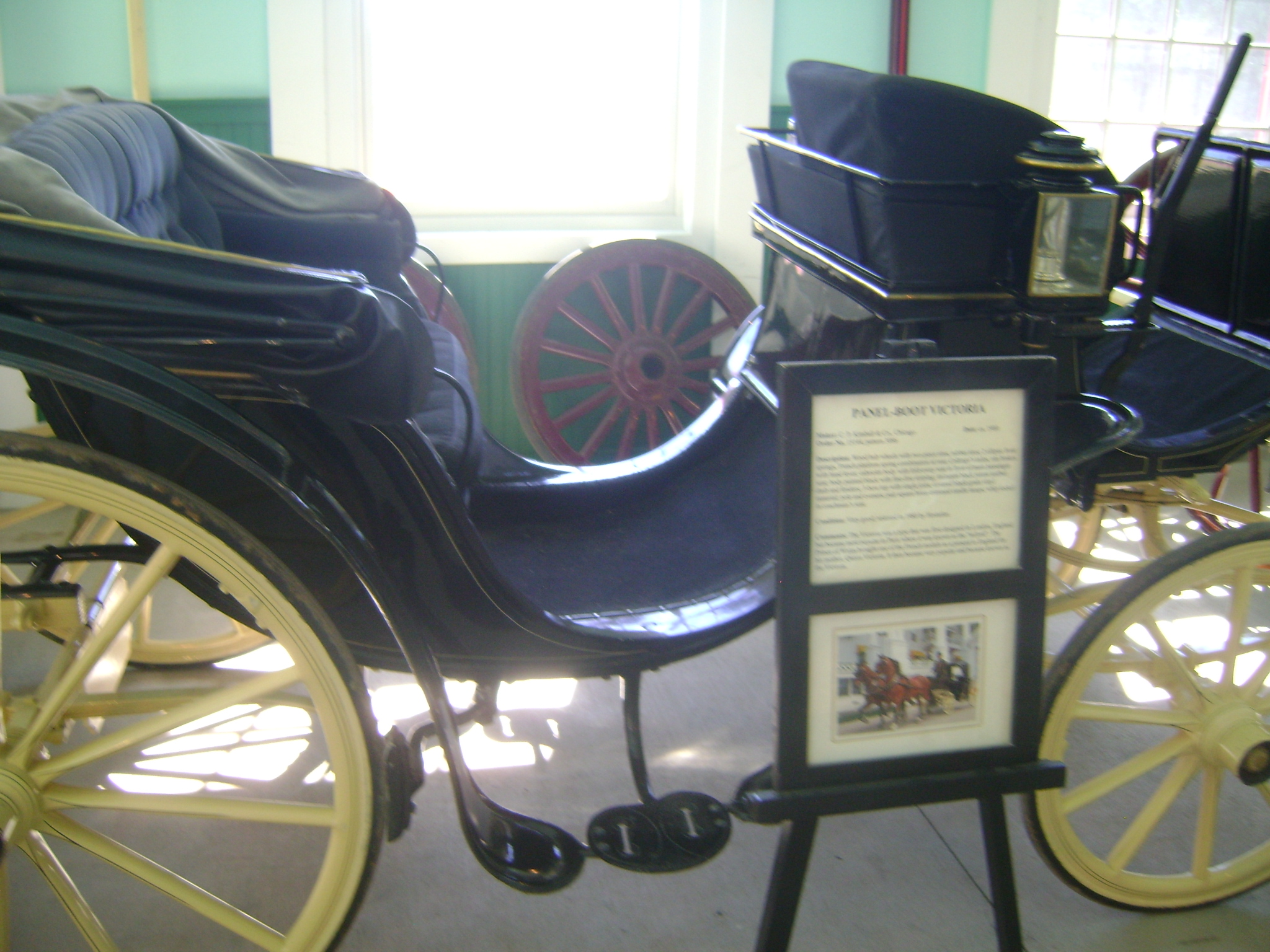 a couple of antique carriages next to some posters