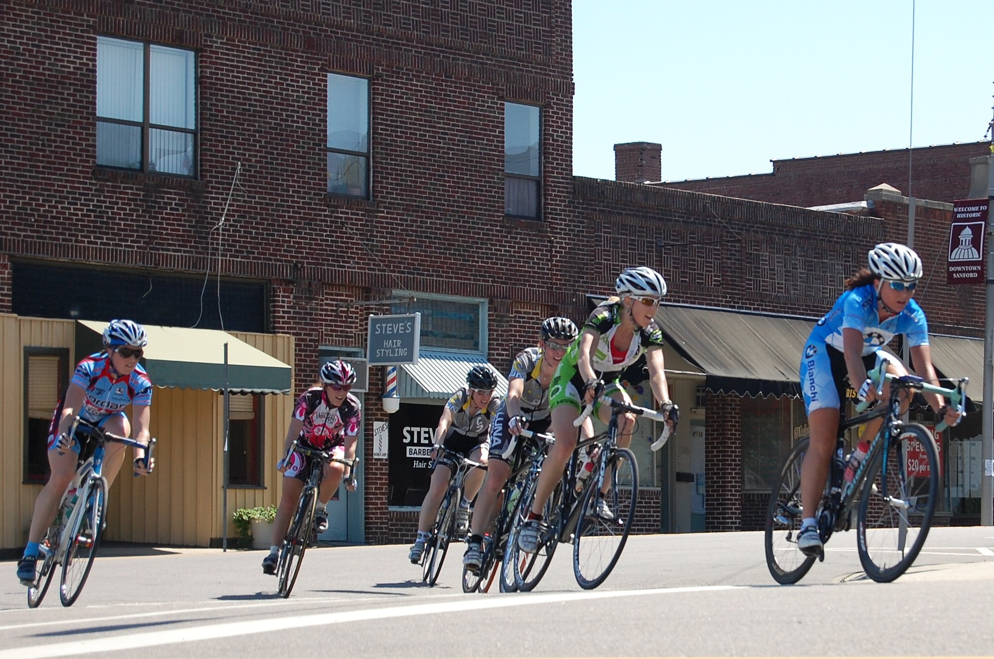 a group of people riding bikes on the street