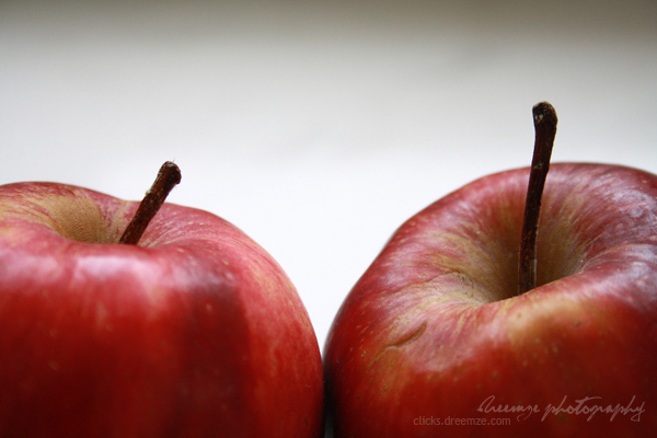 two apples that have been peeled and sitting side by side