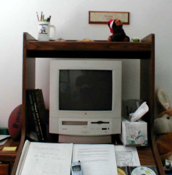 a desk with books and an old television