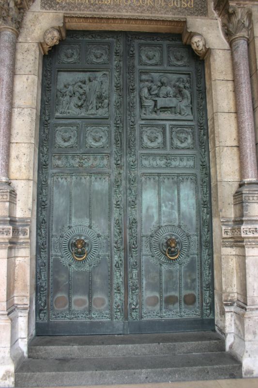 two big door to a building with ornate designs