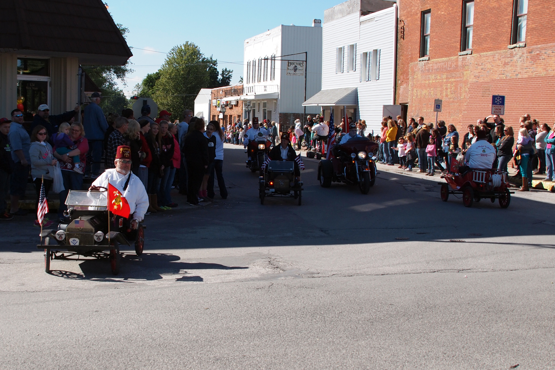 a person driving a motor bike while holding onto a flag