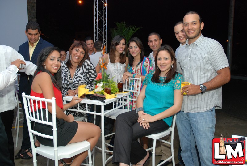 a group of people standing around a table at an event