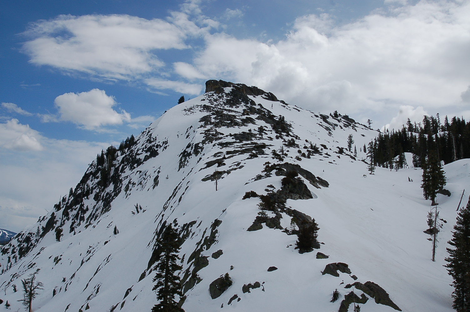 a skier is headed up the steep snowy slope