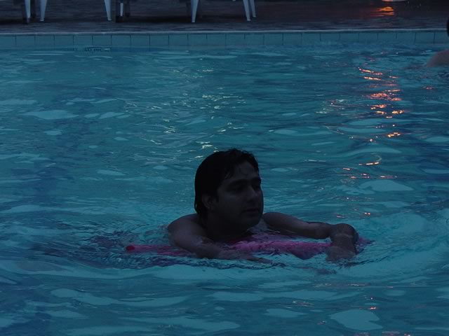 a young person in a pool near some tables