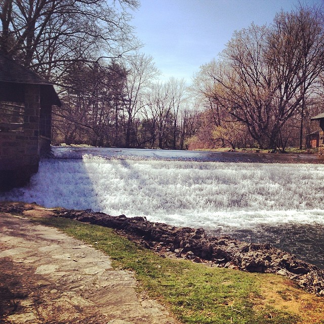 a view of water coming out of a dam