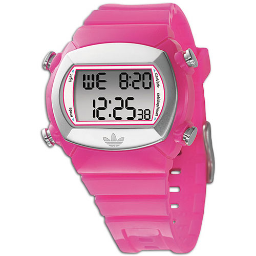 a white and pink digital watch sitting on top of a table