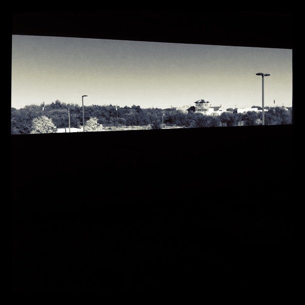 a window view of the city below a parking lot