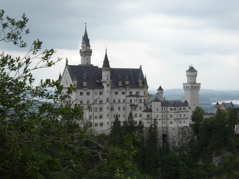 a castle built high on a hill overlooking trees