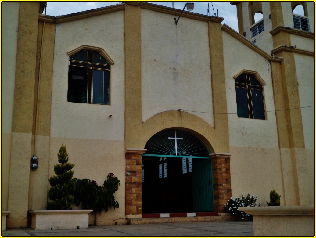 a church entrance with two clocks on each