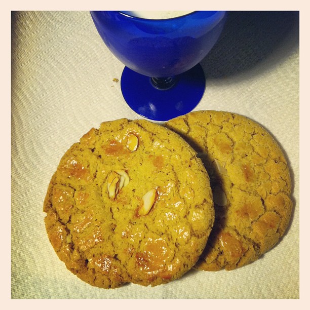 two cookies in front of a bowl of peanut er