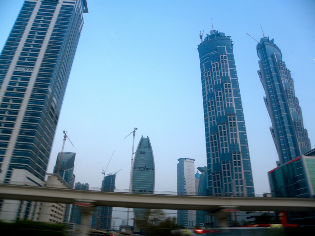 some tall buildings that are next to a highway