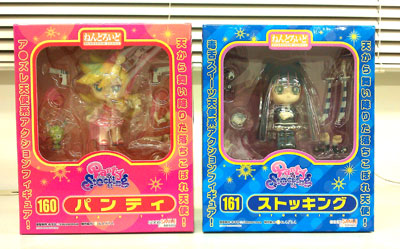 two japanese packaged toys on a white surface