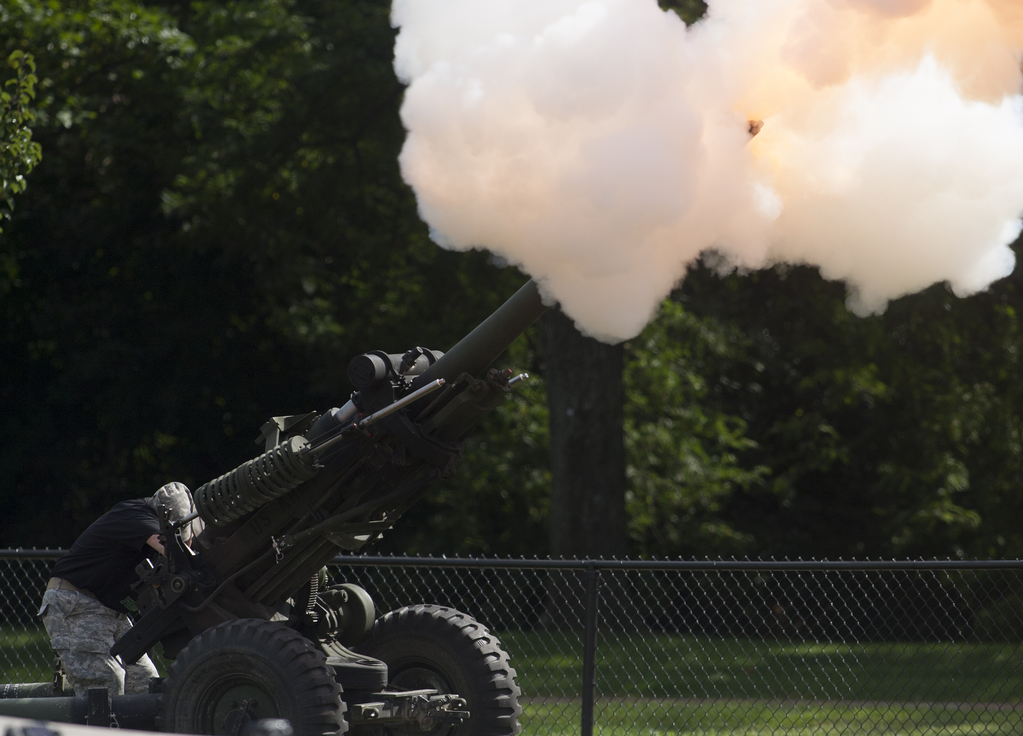 a man is shooting an aim with a gun