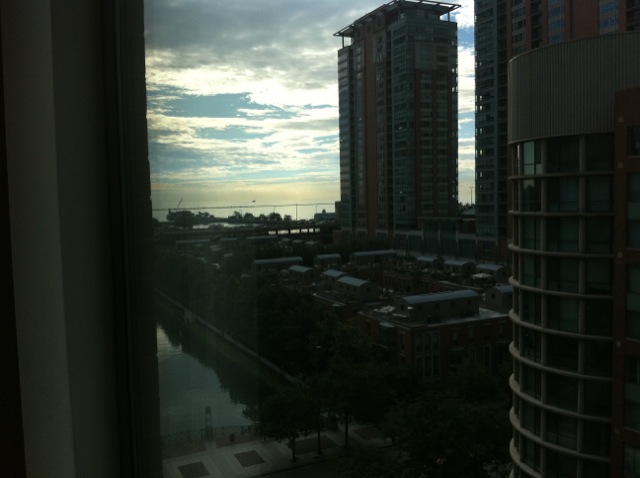 an view of the water in the distance from inside a window